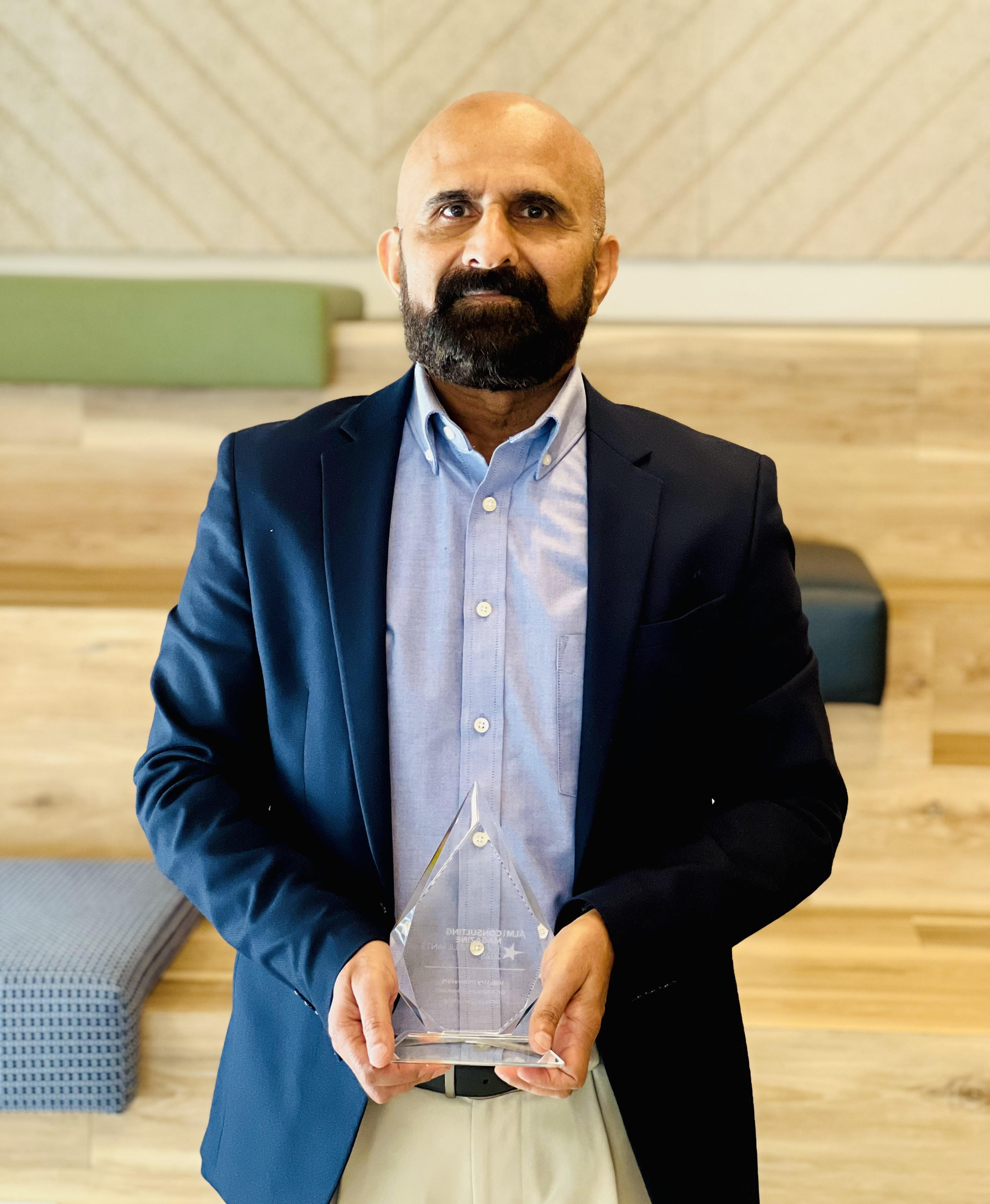 Dr. Sreekumar Menon with a consulting award